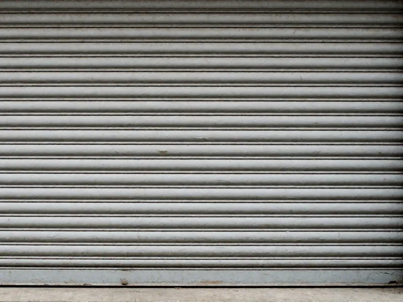A closed workshop roller shutter in flat daylight